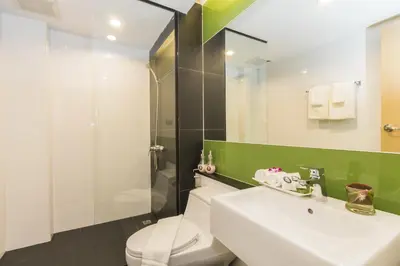 a bathroom with a toilet and a sink and a shower at The Capuchin Hotel Krabi, Ao Nang Beach in Ao Nang Beach