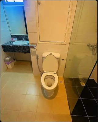 a bathroom with a toilet and a sink at Patong Tower Near Beach in Patong Beach