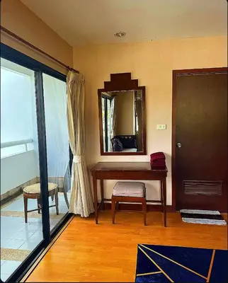 a room with a desk and a mirror and a door at Patong Tower Near Beach in Patong Beach