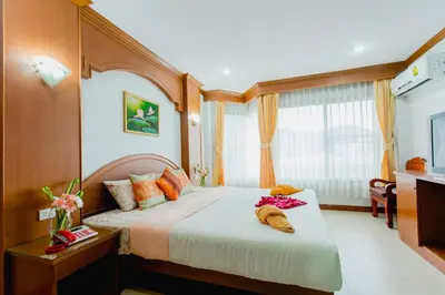 a bedroom with a large bed in a room at RK Guesthouse in Patong Beach