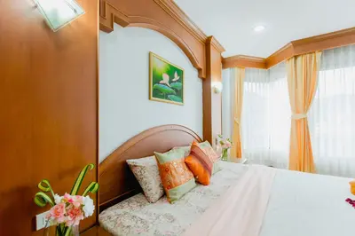 a bedroom with a bed with pillows on it at RK Guesthouse in Patong Beach