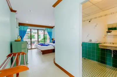 a room with a bedroom and a bed at RK Guesthouse in Patong Beach