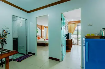 a room with blue walls and a bedroom at RK Guesthouse in Patong Beach