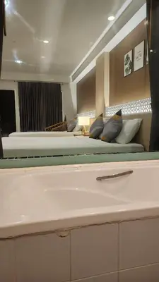 two beds in a large room with two beds at iRest Ao Nang Hostel in Ao Nang Beach