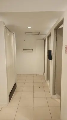 an empty hallway of an office building with a tile floor at iRest Ao Nang Hostel in Ao Nang Beach