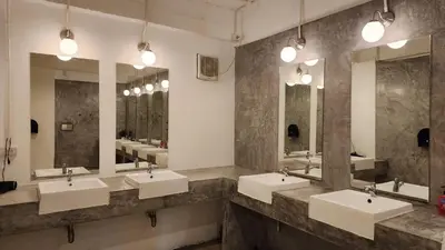 a bathroom with three sinks and three mirrors at iRest Ao Nang Hostel in Ao Nang Beach
