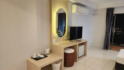 a room with a tv and a living room at iRest Ao Nang Hostel in Ao Nang Beach