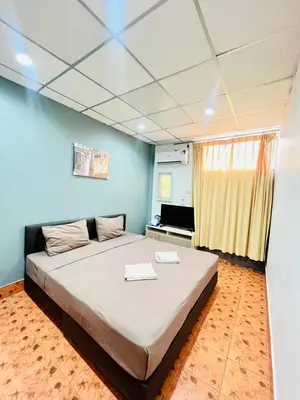 a bedroom with a large bed in a room at Patong Adventure Hostel in Patong Beach