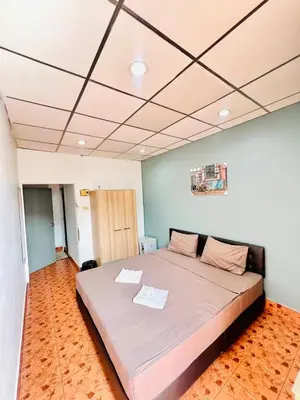 a bedroom with a large bed in a room at Patong Adventure Hostel in Patong Beach