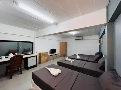 a large room with a large bed and a desk at Patong Adventure Hostel in Patong Beach