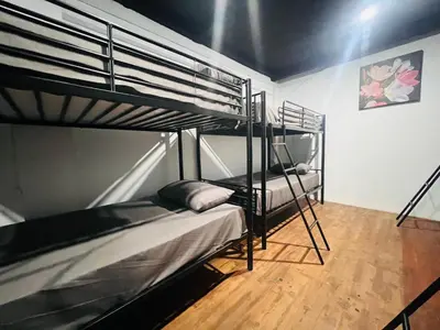 a bedroom with two bunk beds in a room at Patong Adventure Hostel in Patong Beach