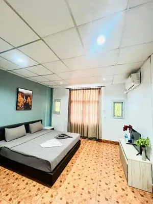 a bedroom with a large bed in a room at Patong Adventure Hostel in Patong Beach