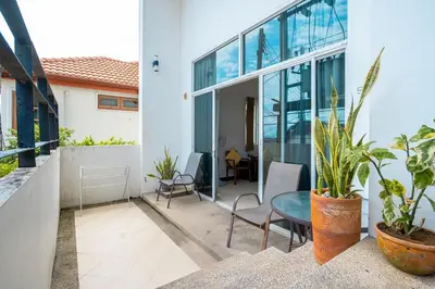 an outdoor patio with a table and chairs at Hillside Seaview Residence in Karon Beach