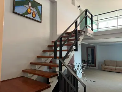 a staircase in a house with a painting on the wall at Hillside Seaview Residence in Karon Beach