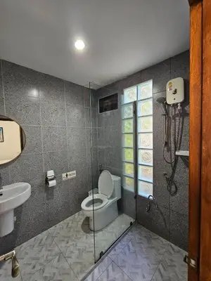 a bathroom with a toilet and a sink at Tropical Oasis Aoyon Beach House in Ban Ao Makham
