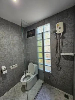 a bathroom with a shower and a toilet in it at Tropical Oasis Aoyon Beach House in Ban Ao Makham