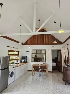 a kitchen with a table and a dining room at Tropical Oasis Aoyon Beach House in Ban Ao Makham