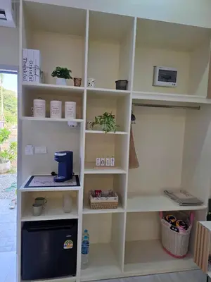 a room with white shelves with a computer on it at Tropical Oasis Aoyon Beach House in Ban Ao Makham