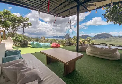 a patio with a table and chairs and a view at Samet Nangshe Goodview in Ban Met Nang Chi