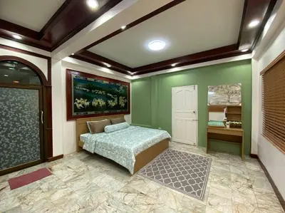 a bedroom with a bed in a room with green walls at Kata#near macro karon # 1km to kata beach in Karon Beach