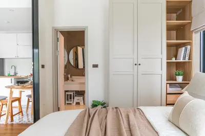 a bedroom with a bed and a kitchen at Title Halo Timeless Naiyang Pool Gym Sauna in Nai Yang Beach