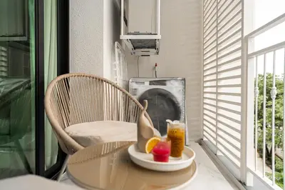 a table with a bowl of fruit and a drink at Title Halo Timeless Naiyang Pool Gym Sauna in Nai Yang Beach