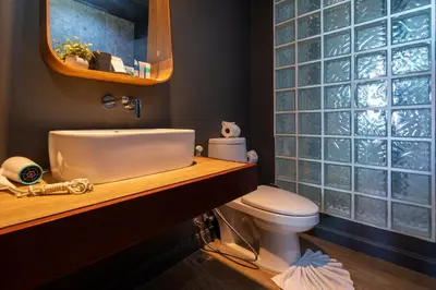 a bathroom with a sink and a toilet and a mirror at Spacious Pool Access Apartment with 2 BR - Rawai in Ban Saiyuan (1)