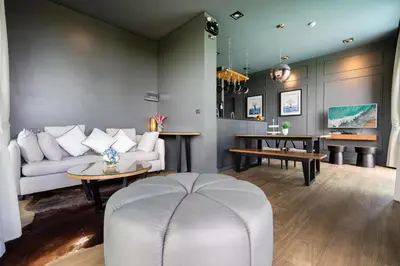 a living room with a couch and a table at Spacious Pool Access Apartment with 2 BR - Rawai in Ban Saiyuan (1)
