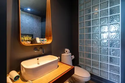 a bathroom with a sink and a toilet and a mirror at Spacious Pool Access Apartment with 2 BR - Rawai in Ban Saiyuan (1)