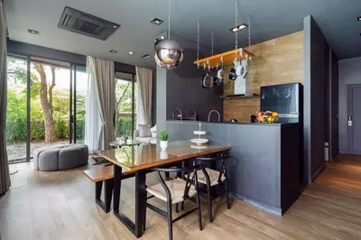 a kitchen and dining room with a dining table at Spacious Pool Access Apartment with 2 BR - Rawai in Ban Saiyuan (1)