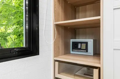 a small microwave sitting on a shelf next to a window at The Title Halo NaiYang by My Home Phuket in Nai Yang Beach