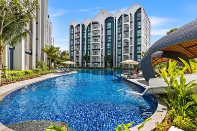 a swimming pool in front of a building at The Title Halo NaiYang by My Home Phuket in Nai Yang Beach
