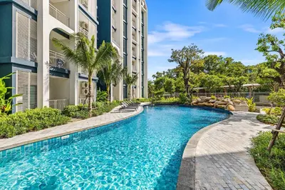 a swimming pool in front of a building at The Title Halo NaiYang by My Home Phuket in Nai Yang Beach