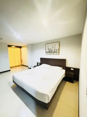 a bedroom with a large white bed in it at La Casa Patong in Patong Beach