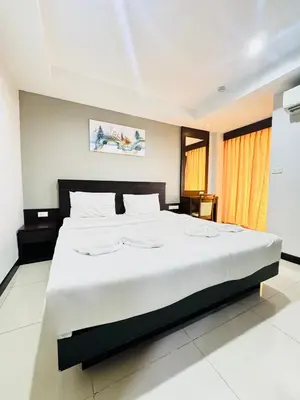 a bedroom with a large white bed in a room at La Casa Patong in Patong Beach