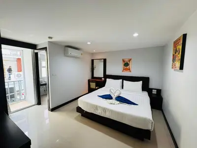 a bedroom with a bed with a blue towel on it at La Casa Patong in Patong Beach