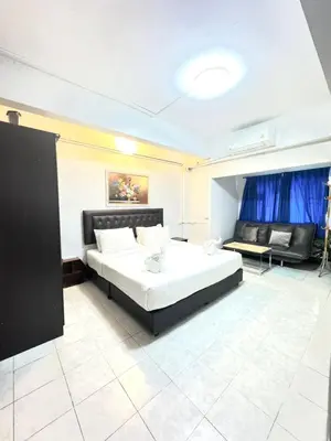 a large bedroom with a bed and a couch at La Casa Patong in Patong Beach