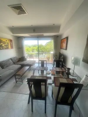 a living room with a couch and a table at Rawai apartments in Ban Saiyuan (1)
