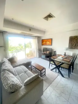 a living room with a couch and a table at Rawai apartments in Ban Saiyuan (1)
