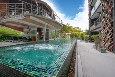 a swimming pool in front of a building at Studio Apartment - Emerald Terrace Patong in Patong Beach