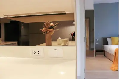 a view of a room with a bed and a kitchen at Cassia Residences Sea View in Laguna Phuket