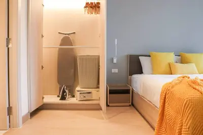 a bedroom with a bed and a tv in a room at Cassia Residences Sea View in Laguna Phuket