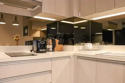 a kitchen with white cabinets and a counter top at Cassia Residences Sea View in Laguna Phuket