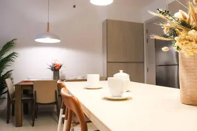 a kitchen and dining room with a table and chairs at Cassia Residences Sea View in Laguna Phuket