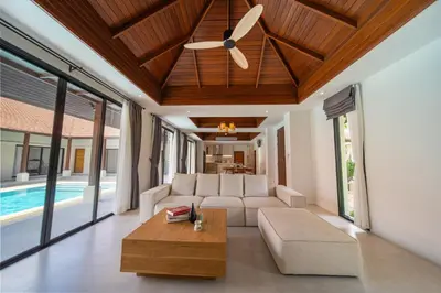 a living room with a couch and a ceiling fan at Luxury 4 Bedrooms 800 square meters of large space Private swimming pool private kitchen service Family and friends vacation in Bang Tao Beach