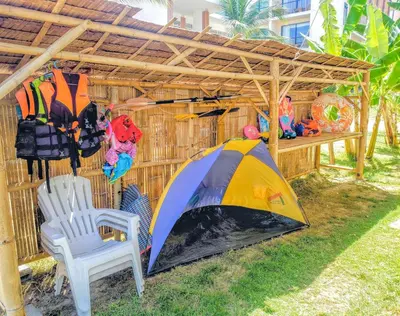 a tent and a chair under a wooden shed at Beach Front Queen's Castle - Kid friendly, Holiday like Royalty in Ban Ao Makham