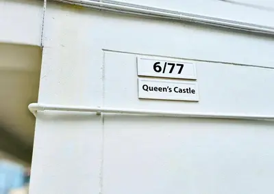 a white building with a sign that reads queens castle at Beach Front Queen's Castle - Kid friendly, Holiday like Royalty in Ban Ao Makham