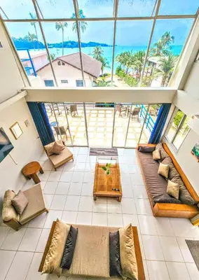 a living room with a view of the ocean at Beach Front Queen's Castle - Kid friendly, Holiday like Royalty in Ban Ao Makham