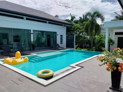 a swimming pool with a rubber duck in front of a house at VILLA DESTINY - Luxury Villa Near Nai Harn Beach in Ban Saiyuan (1)
