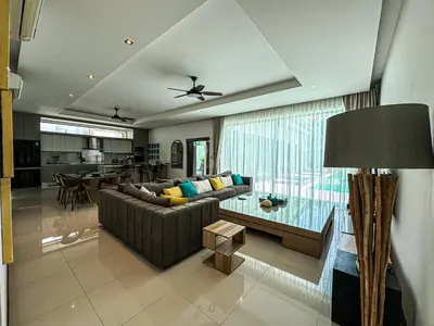 a living room with a couch and a glass table at VILLA DESTINY - Luxury Villa Near Nai Harn Beach in Ban Saiyuan (1)